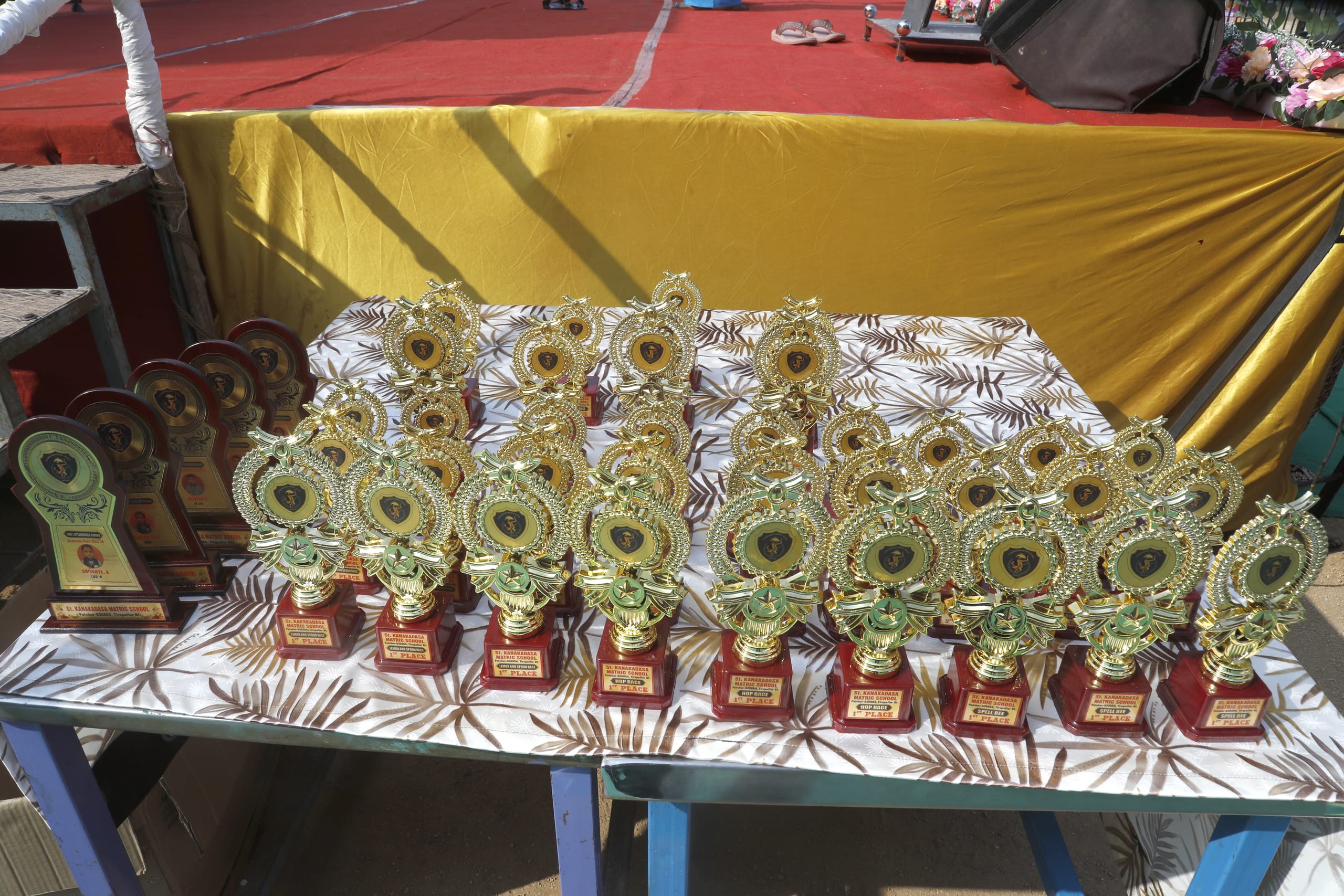 Trophies displayed on a table for an awards ceremony
