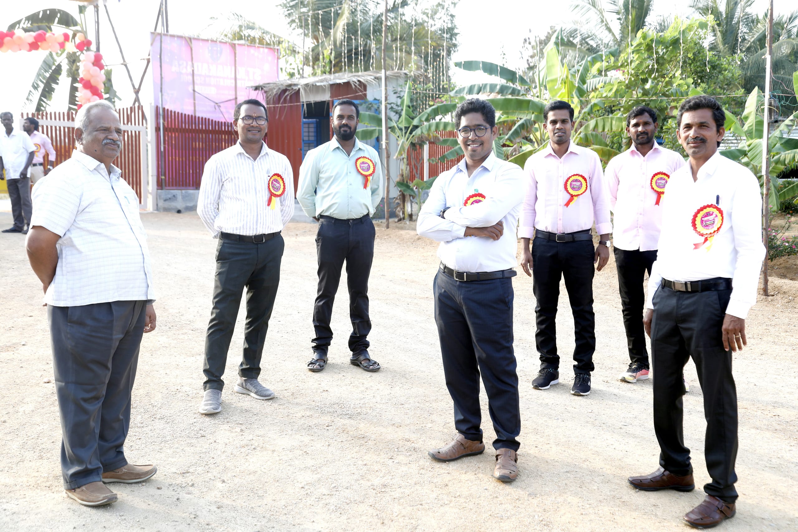 Group of staff and guests standing outdoors at the school