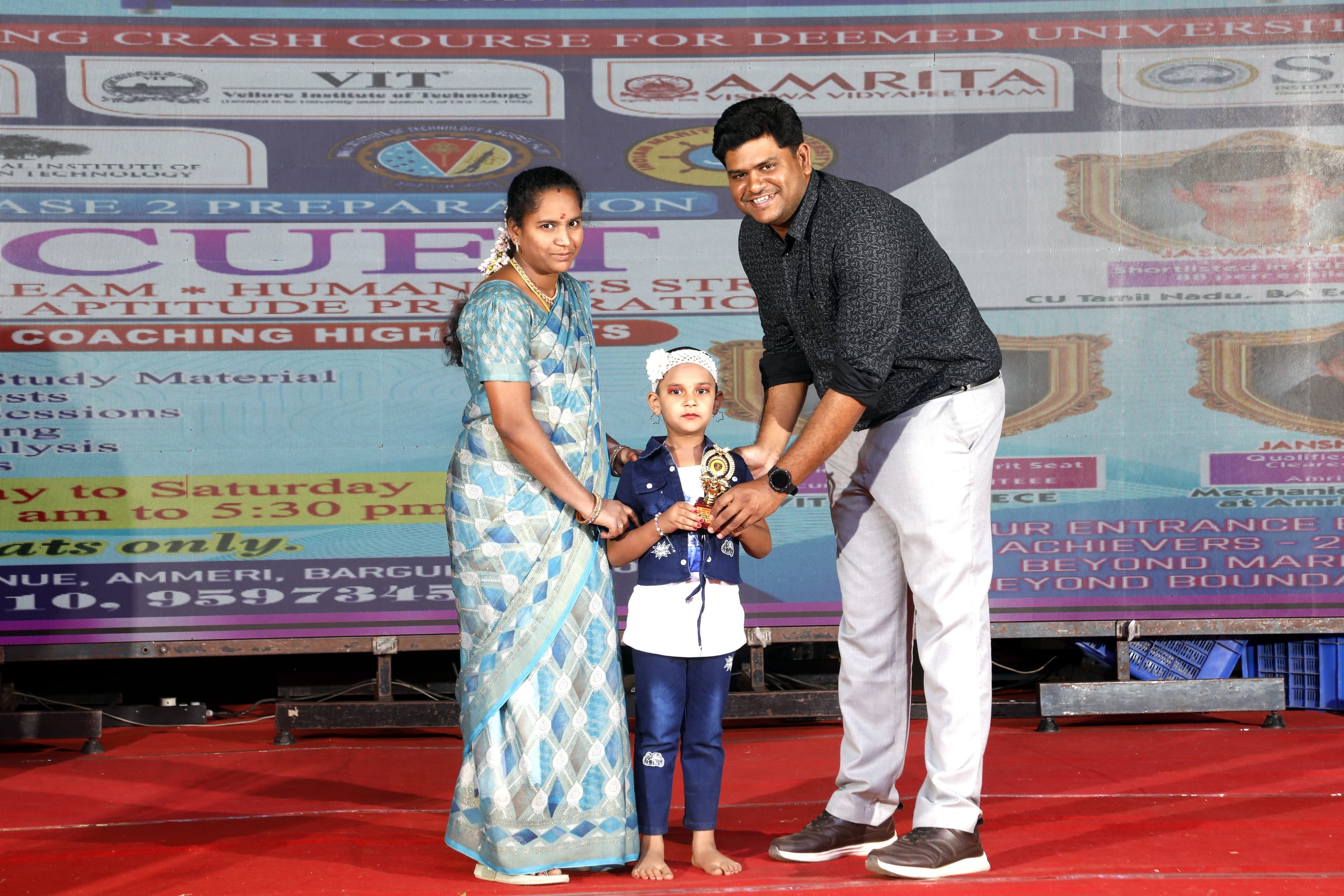 Small boy receiving a trophy on stage