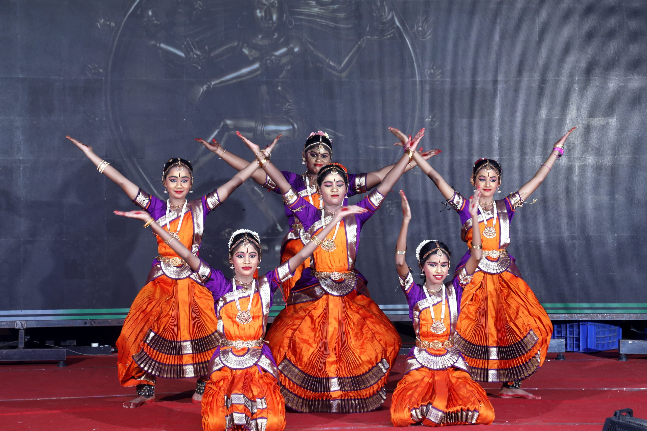 Students in classical dance costumes posing on stage
