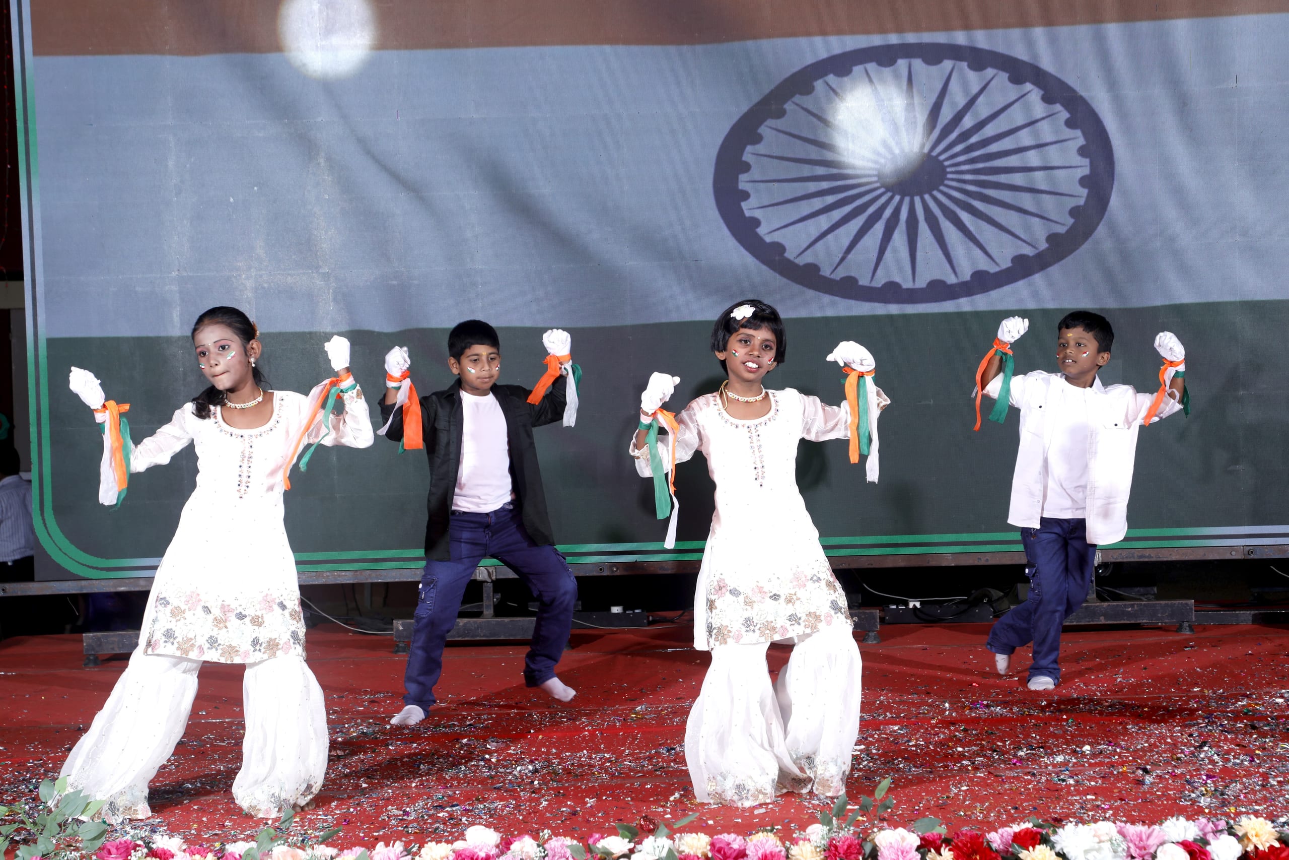 Students performing a patriotic dance on stage