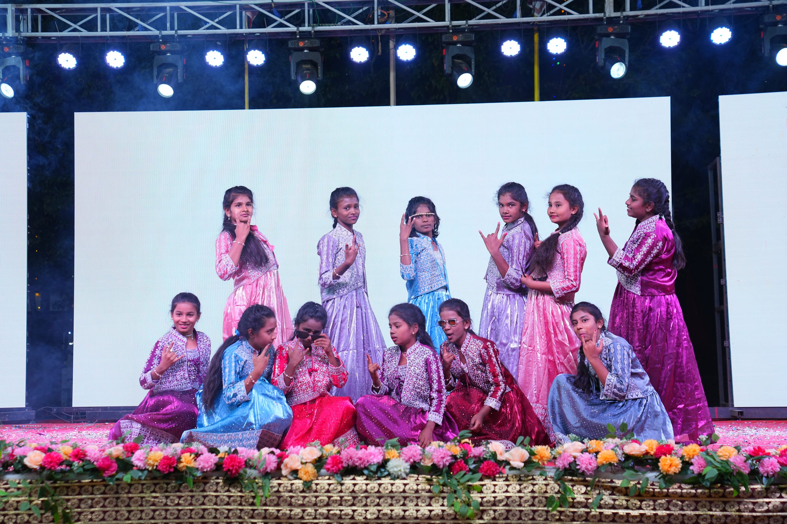 Students in colourful costumes during a group performance