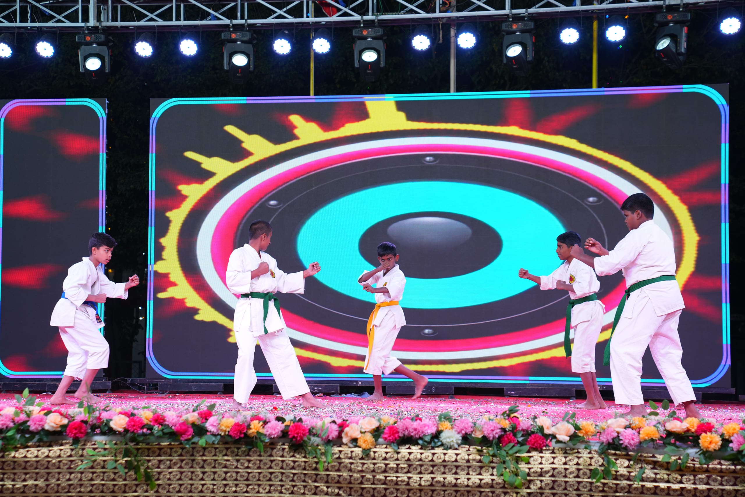 Students demonstrating karate on stage
