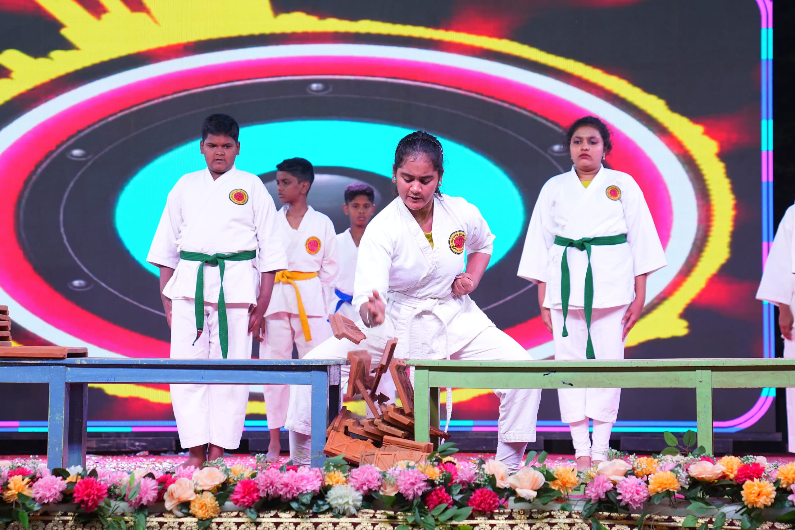 Student striking boards in a karate demonstration