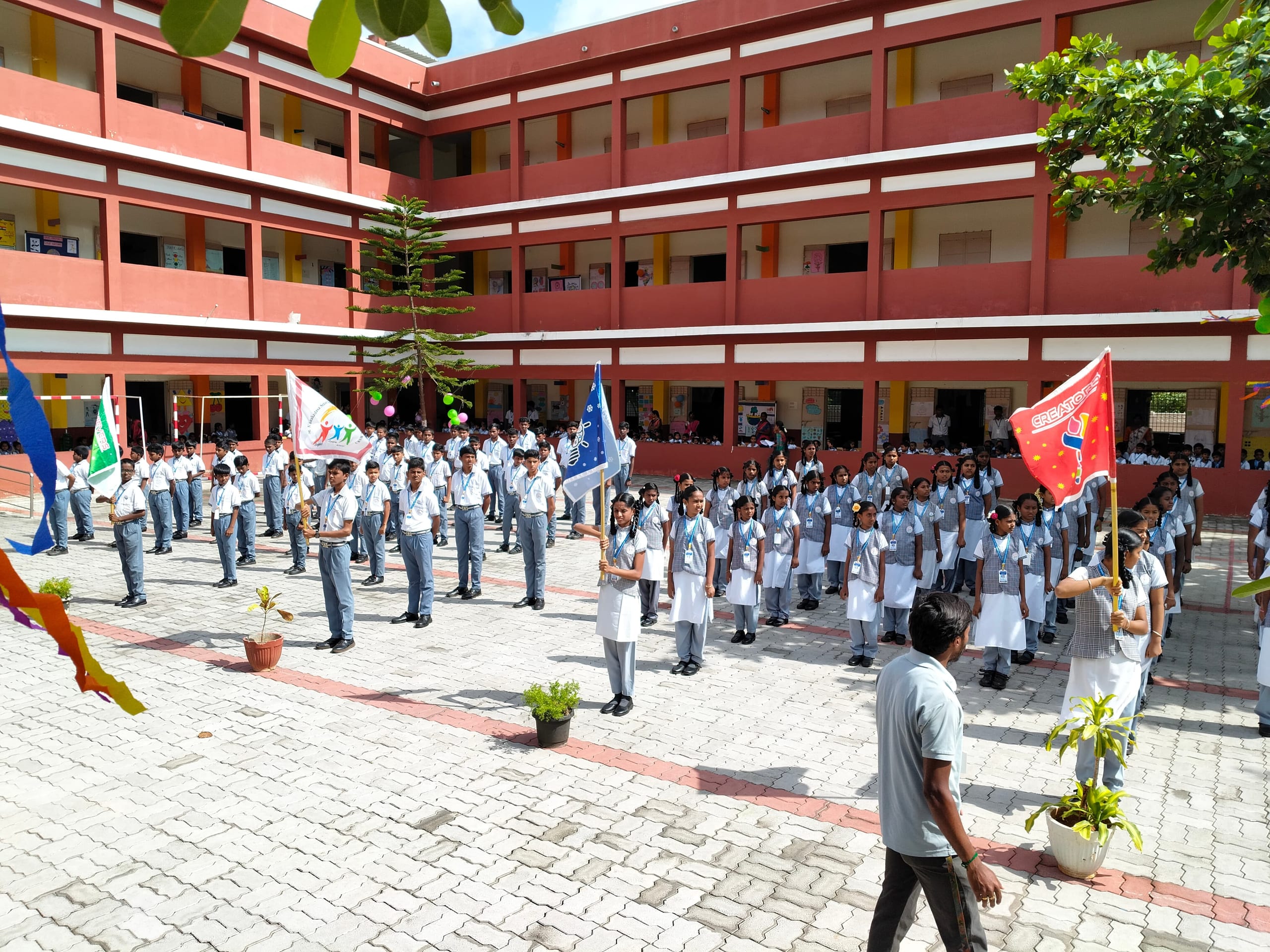 Students assembled in rows in the school courtyard