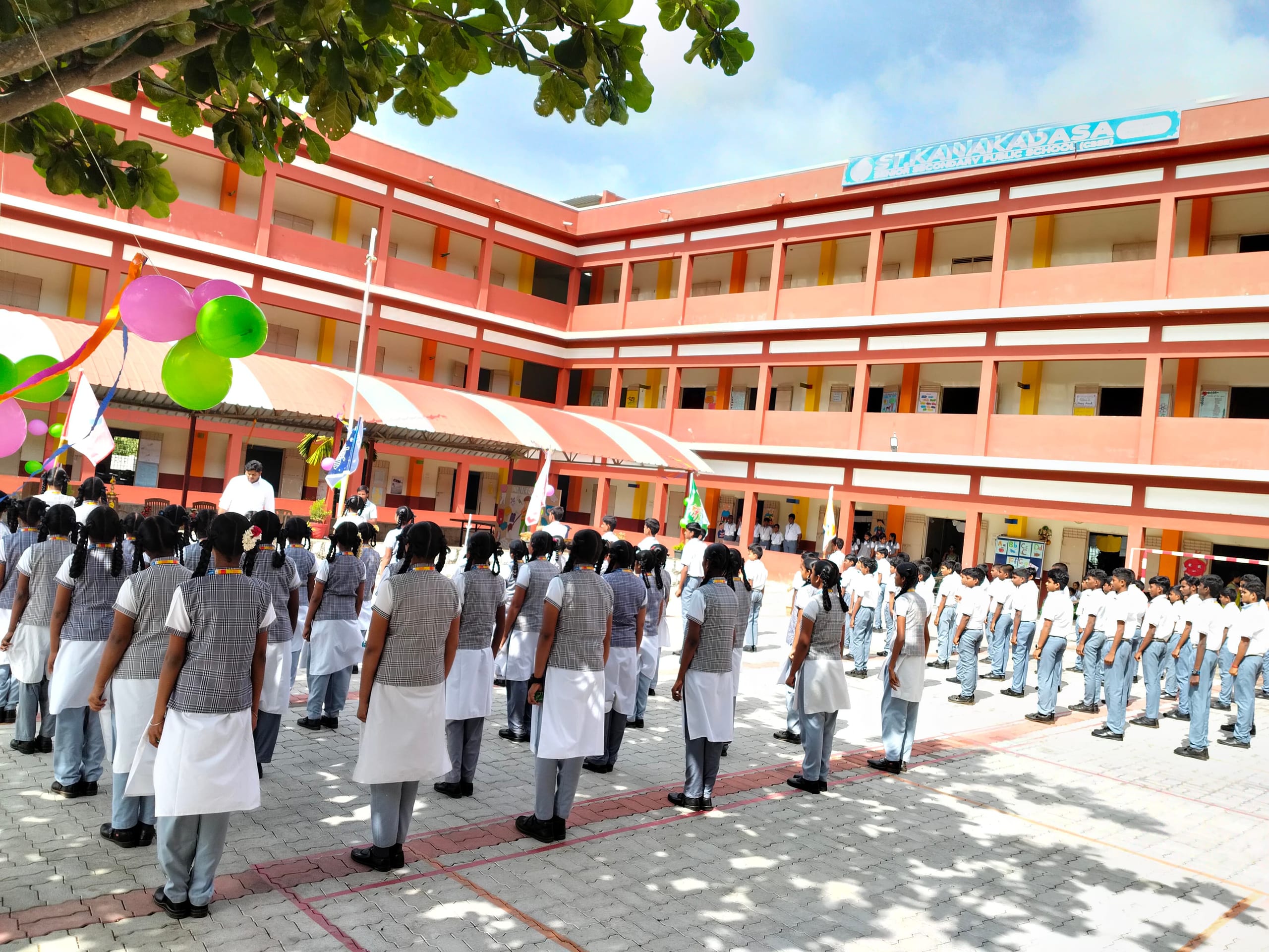 Students lined up in the courtyard viewed from the side