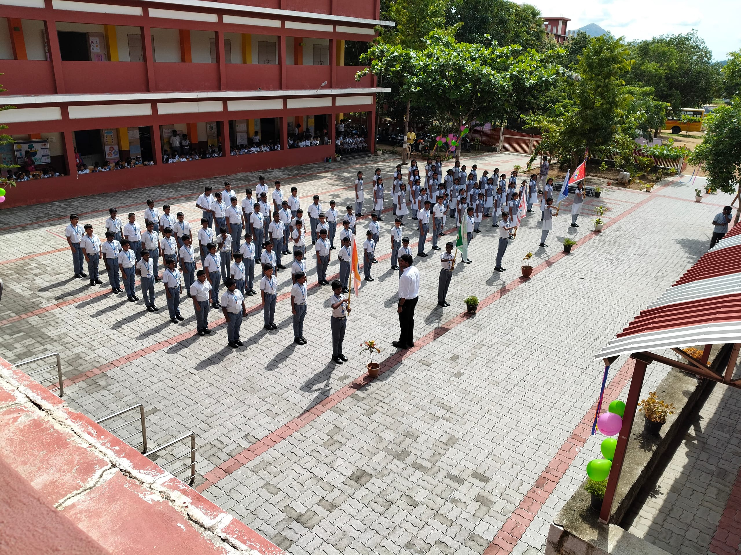 Wide view of students standing in rows at assembly
