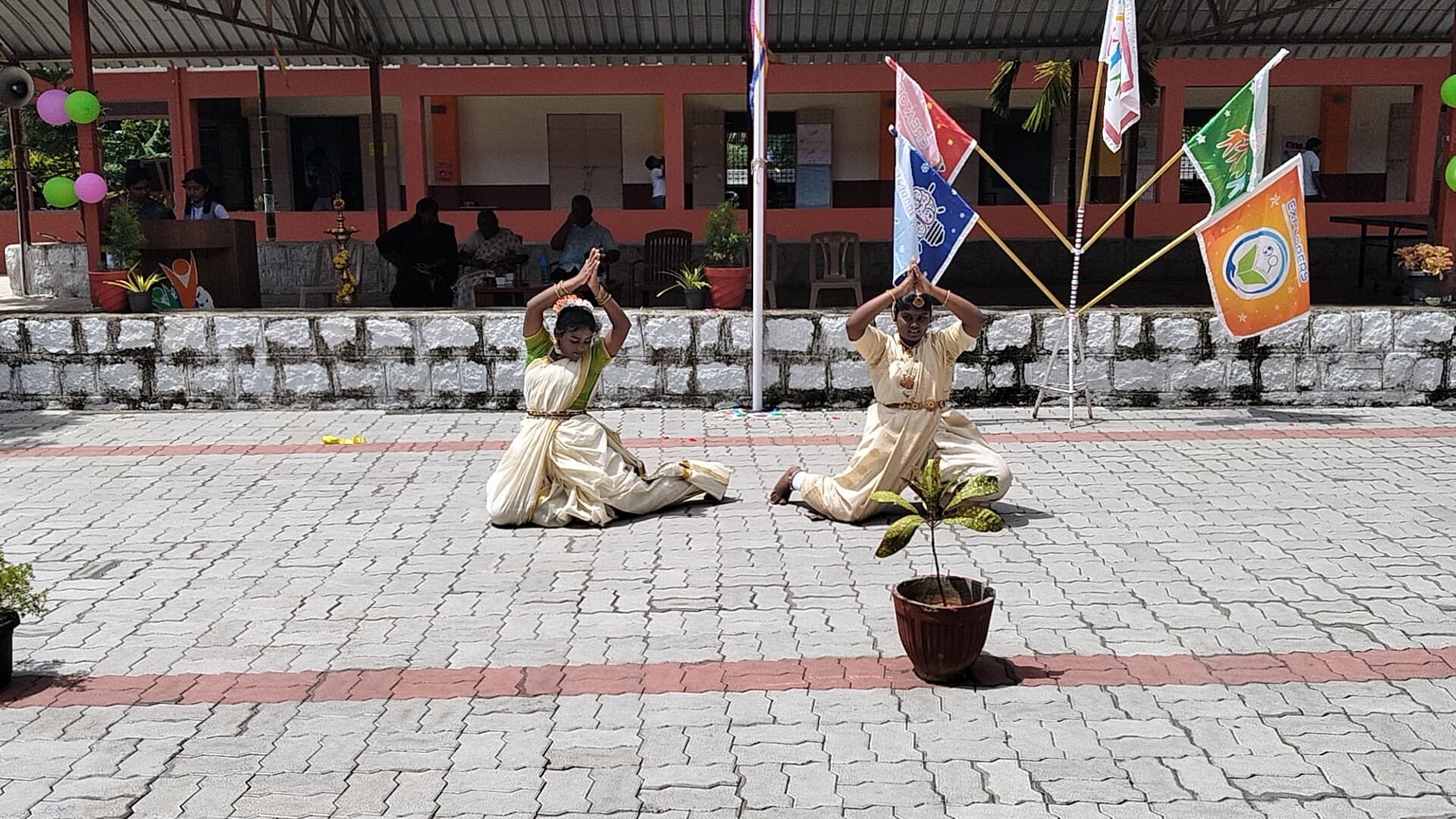 Students performing yoga and dance in the courtyard