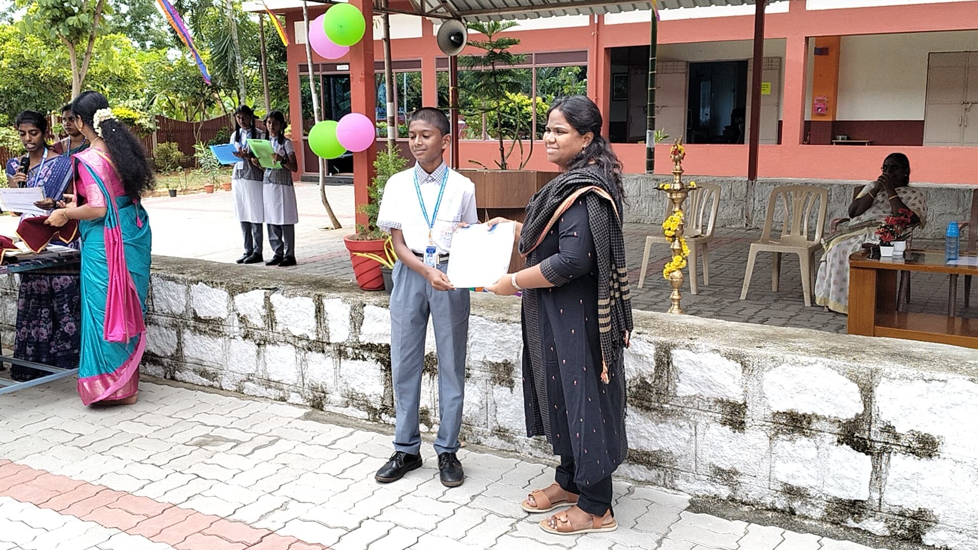 Student receiving a certificate from a staff member