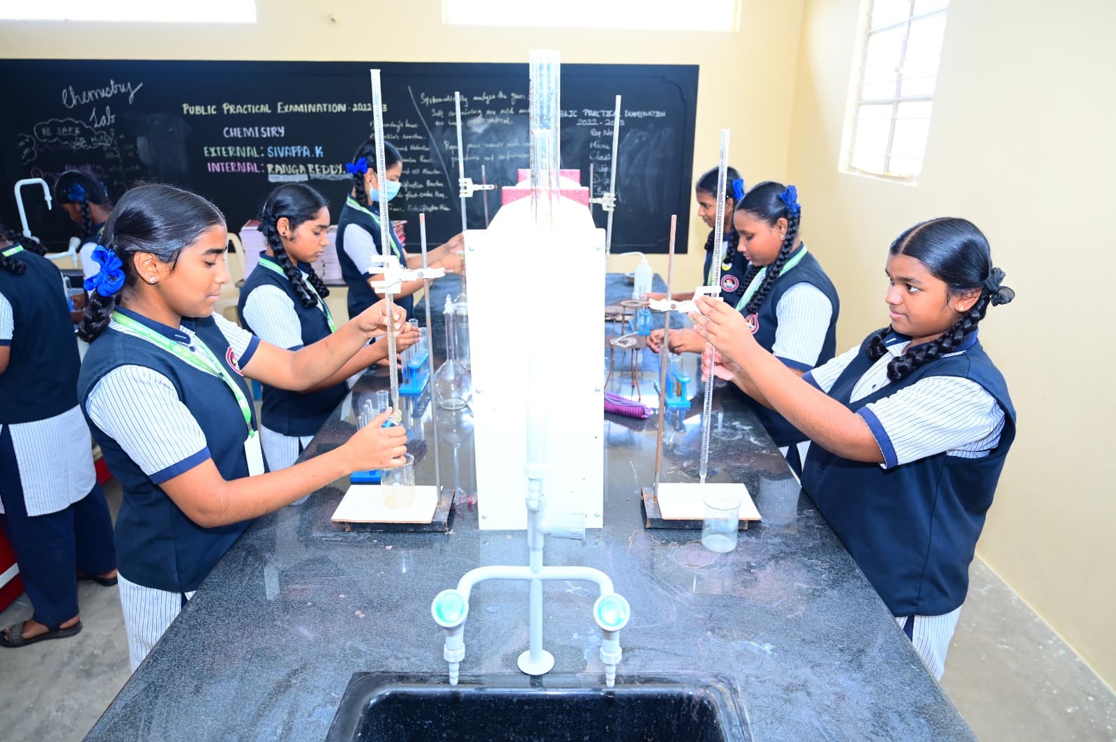 Students performing chemistry experiments in the laboratory