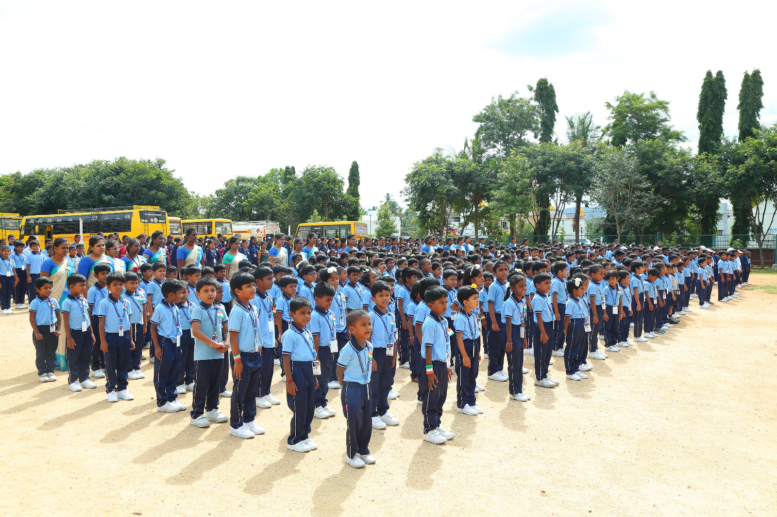 Students assembled on the open sports ground at St. Kanakadasa